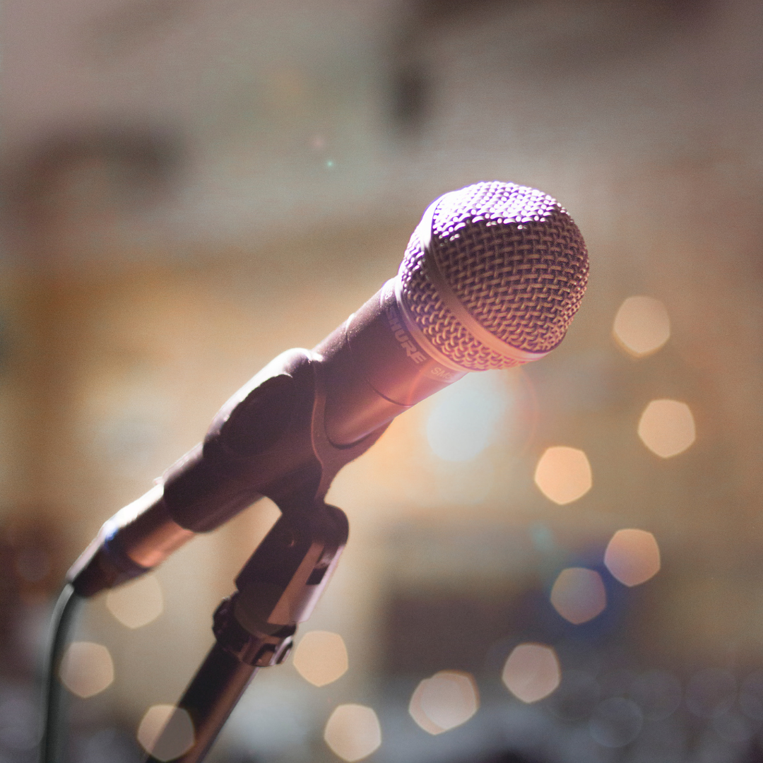 a microphone on a stand with a blurry background